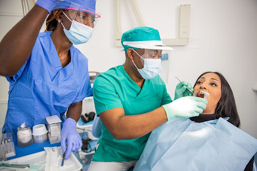 A team of dentists and hygienists perform a root canal on a patient.